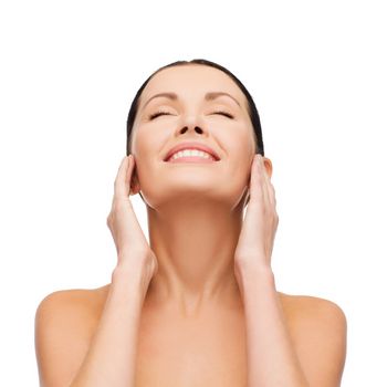 health, spa and beauty concept - clean face and hands of beautiful smiling woman with closed eyes