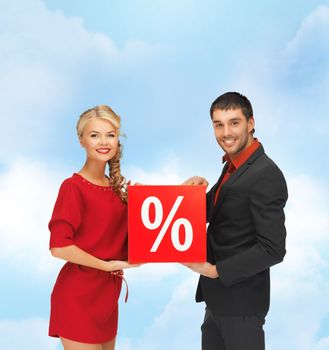 sale and shopping concept - smiling man and woman with percent sign