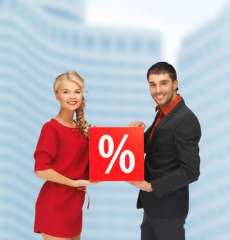 shopping and sale concept - smiling man and woman with percent sign outdoors