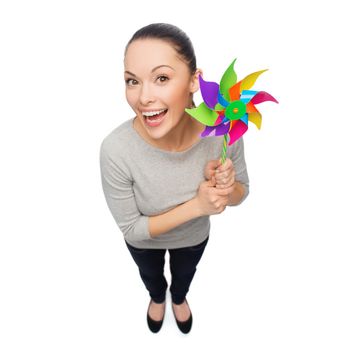 happiness and ecology concept - smiling asian woman with windmill