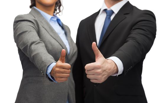 business and office concept - businessman and businesswoman showing thumbs up