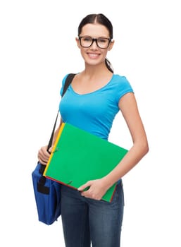 education and people concept - female student in eyeglasses with bag and folders