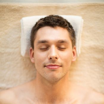 healthcare, spa and beauty concept - close up of man face in spa salon