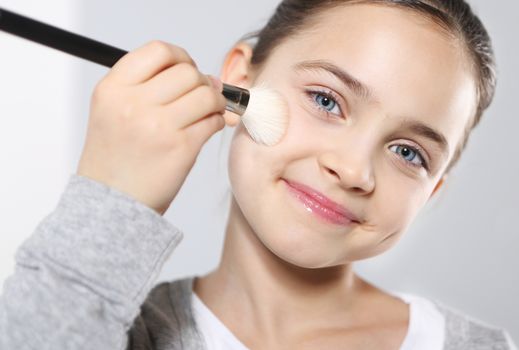 Young teenage girl with brushes for make-up