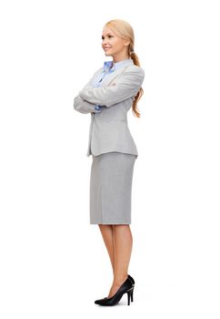 business and education concept - friendly young smiling businesswoman with crossed arms