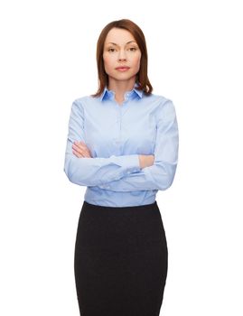 business and education concept - friendly young businesswoman with crossed arms