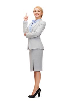 business and education concept - attractive young businesswoman with her finger up