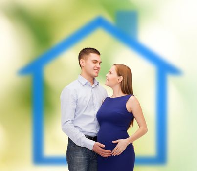 pregnancy, real estate, parenthood and happiness concept - happy young family expecting child looking at each other