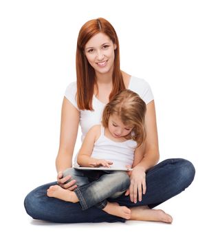 childhood, parenting and technology concept - happy mother with adorable little girl and tablet pc computer