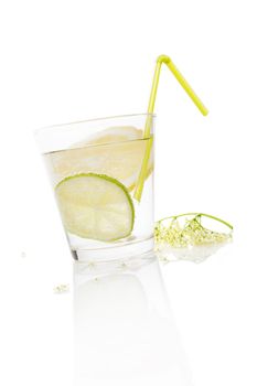 Delicious fresh healthy summer lemonade drinking. Water with lemon and fresh elderberry blossom. Refreshing nonalcoholic organic fresh drink.