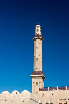 Minaret in the centre of Duabi against a blue sky. UAE