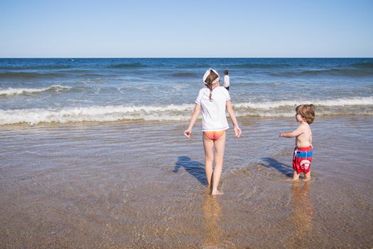 Kids playing in the water at the sea