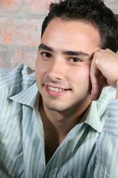 Brunette male model against a brickwall background