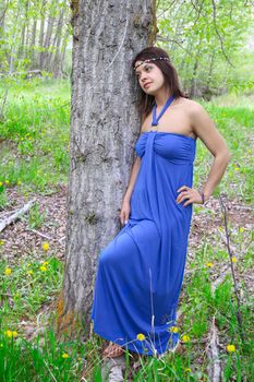 Brunette female wearing a blue dress outdoors