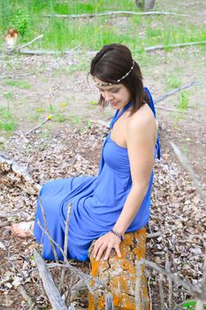 Brunette female wearing a blue dress outdoors 