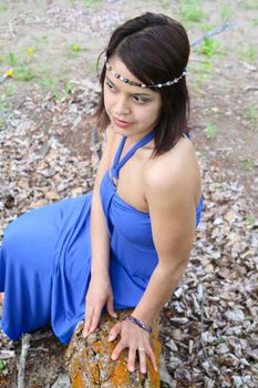 Brunette female wearing a blue dress outdoors 