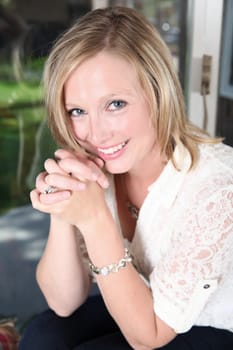 Portrait shot of beautiful blond woman against a window