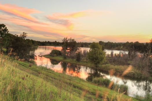 A beautiful sunset over Penrith Lakes near Castlereagh with Blue Mountains in distance.  The area was one of the first rural settlements in Australia and is one of the five Macquarie towns