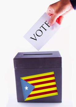 Urn for vote, with male hand posting vote and Catalunya banner