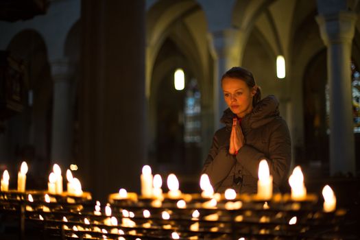 Young woman praying in a church