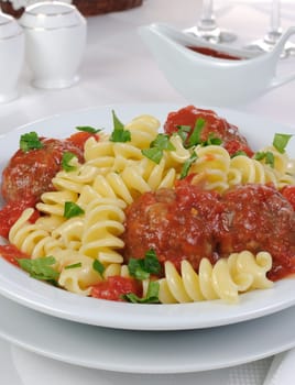 Pasta with meatballs in tomato sauce and herbs

