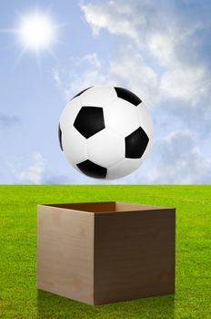 Football in open box with field background