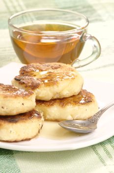 Delicious homemade cheese pancakes with honey closeup