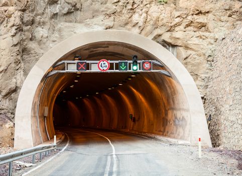 Entrance to a road tunnel with traffic signs