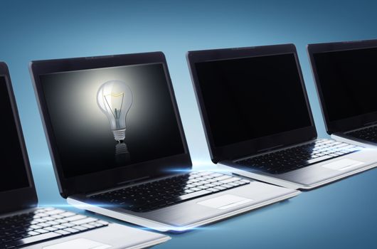 technology and advertisement concept - many laptop computers with blank black screens