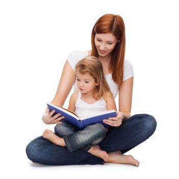 childhood, parenting and relationship concept - happy mother with adorable little girl reading book