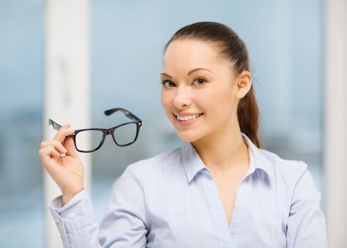 business and education concept - laughing businesswoman with eyeglasses