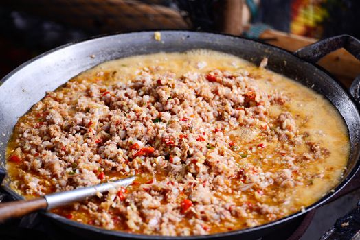 Thai spicy food basil ground pork fried in big pan (Krapao)