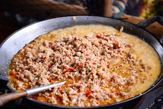 Thai spicy food basil ground pork fried in big pan (Krapao)