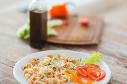cooking, food and home concept - close up of pasta meal on plate