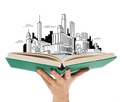 education and book concept - close up of woman hand holding open green book with city sketch