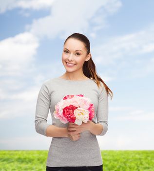 holidays, love and flowers concept - young woman with bouquet of flowers