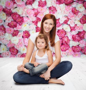 childhood, parenting and relationship concept - happy mother with adorable little girl