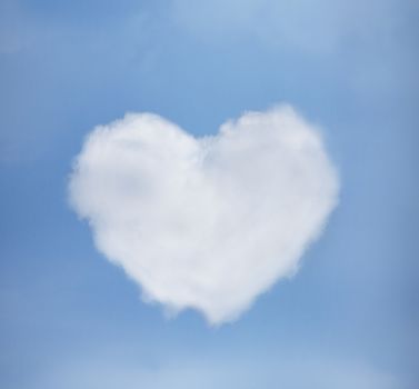 love and relationship concept - blue sky with heart from clouds