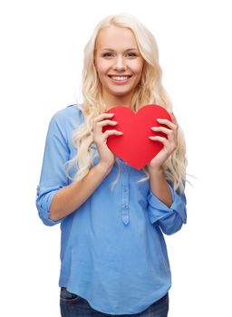 happiness, health and love concept - smiling woman with red heart