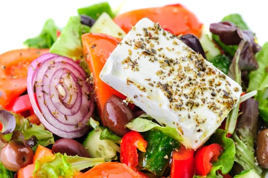 closeup of greek salad with large piece of feta