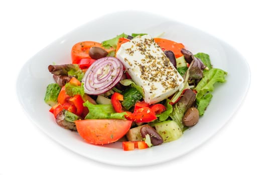 closeup of greek salad with large piece of feta