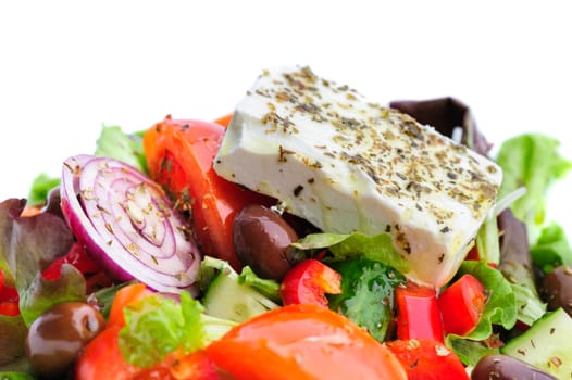 closeup of greek salad with large piece of feta