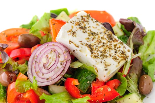 closeup of greek salad with large piece of feta