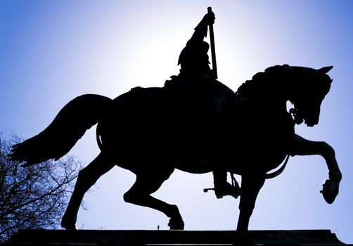 Silhouette of a statue of a knight in a dutch square