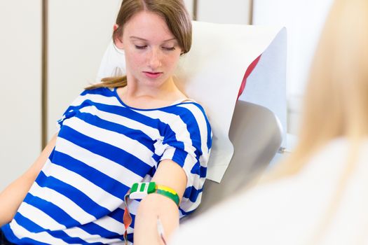 Young blood donor at donation.