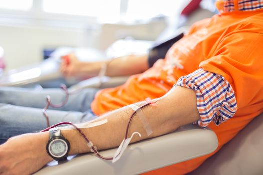 Blood donor at donation with a bouncy ball holding in hand.