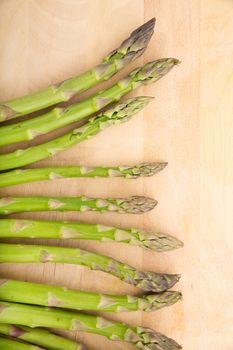 Fresh Asparagus on a wooden tablet.