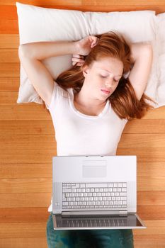 A young woman surfing on the Internet with a Laptop.  
