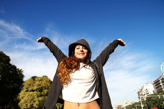 A young woman enjoying the sunlight in the Park.			