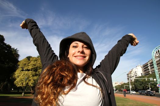 A young woman enjoying the sunlight in the Park.			